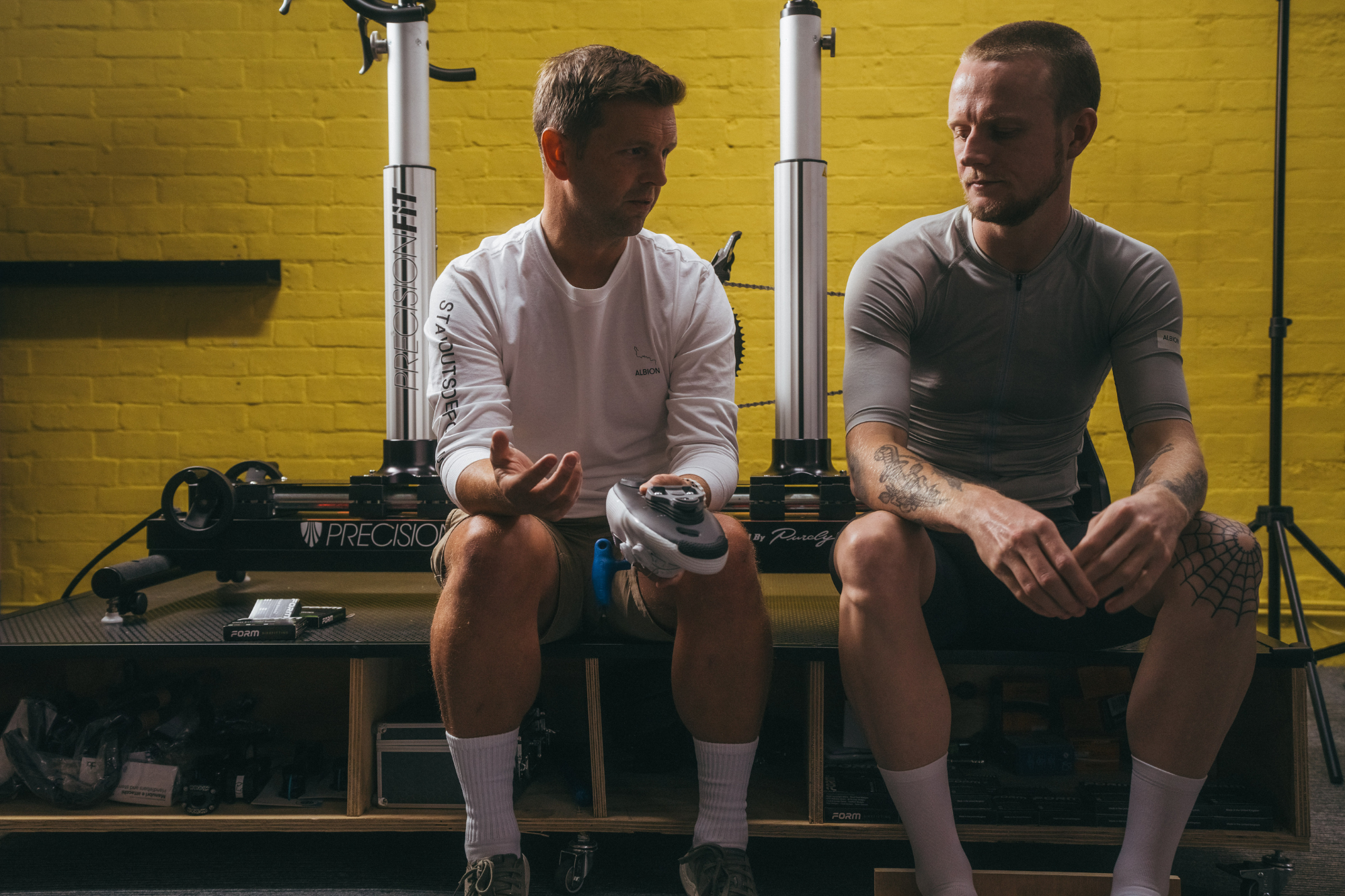 Bikefitter and cyclist chatting next to the cycling jig.